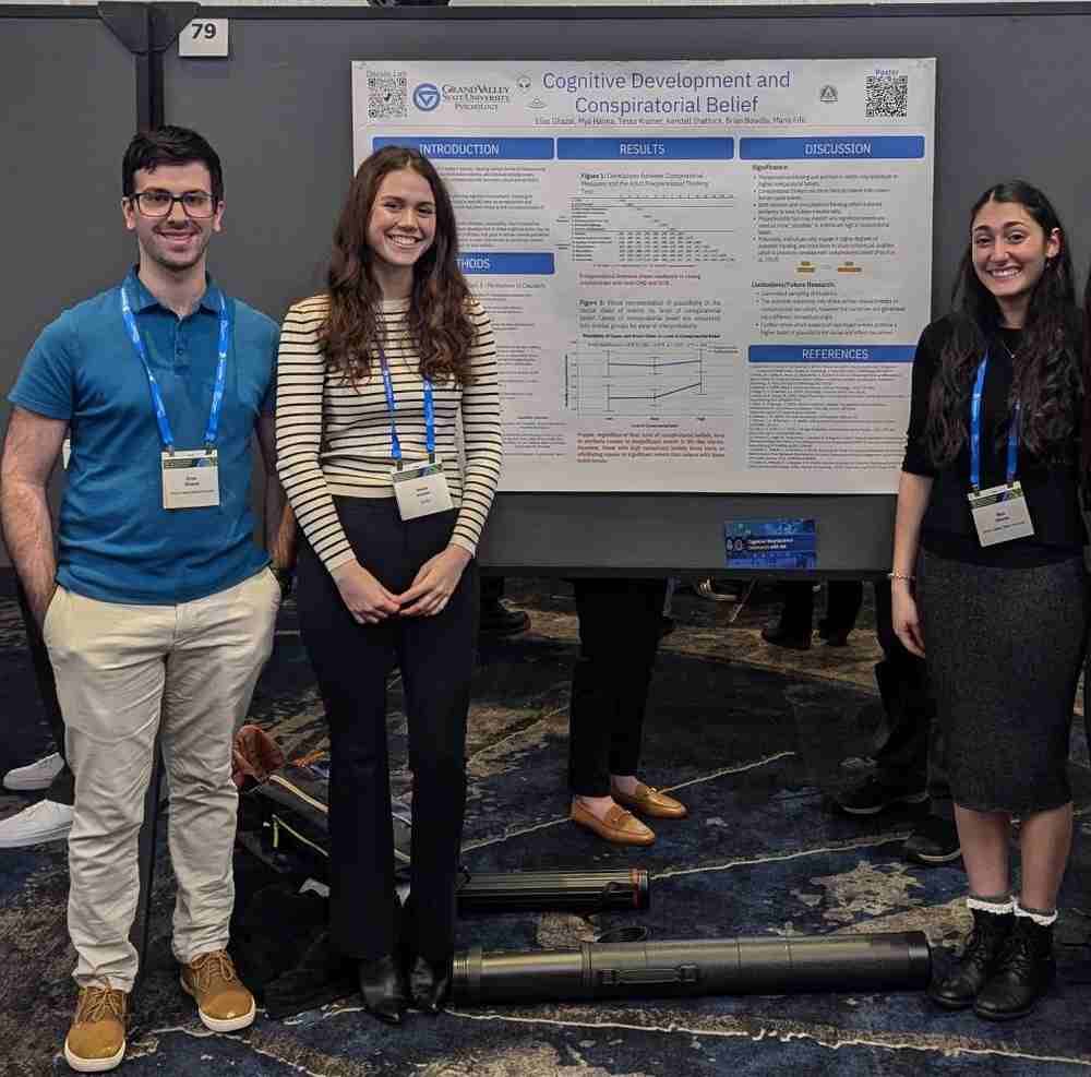 Elias Ghazal, Mya Hanna, & Tessa Kramer standing with their research poster